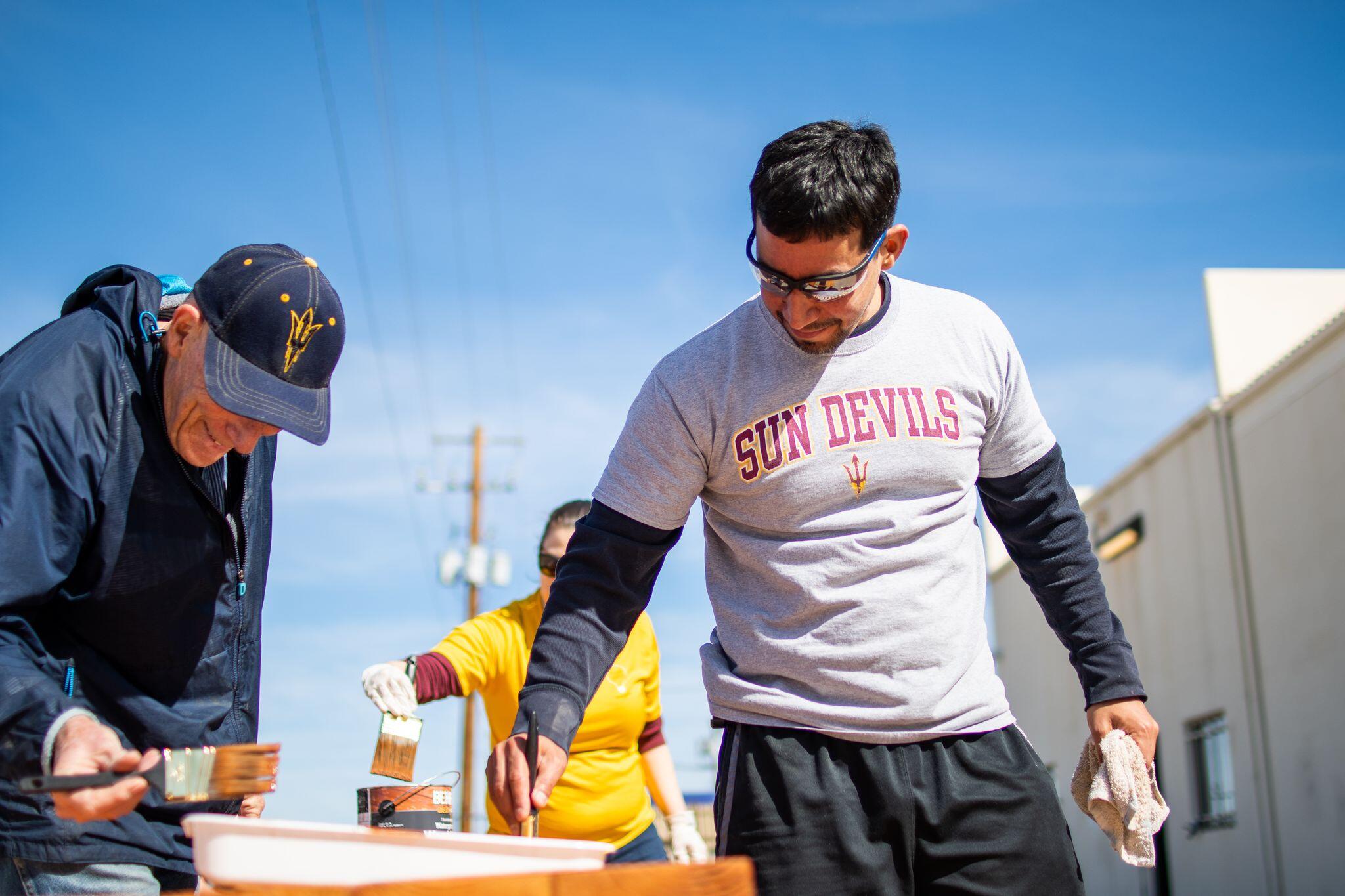 Three Sun Devils fans painting